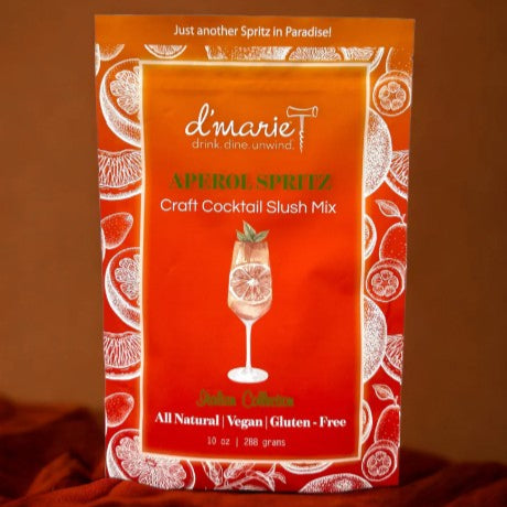 Red package of d'marie Aperol Spritz craft cocktail slush mix on a brown background