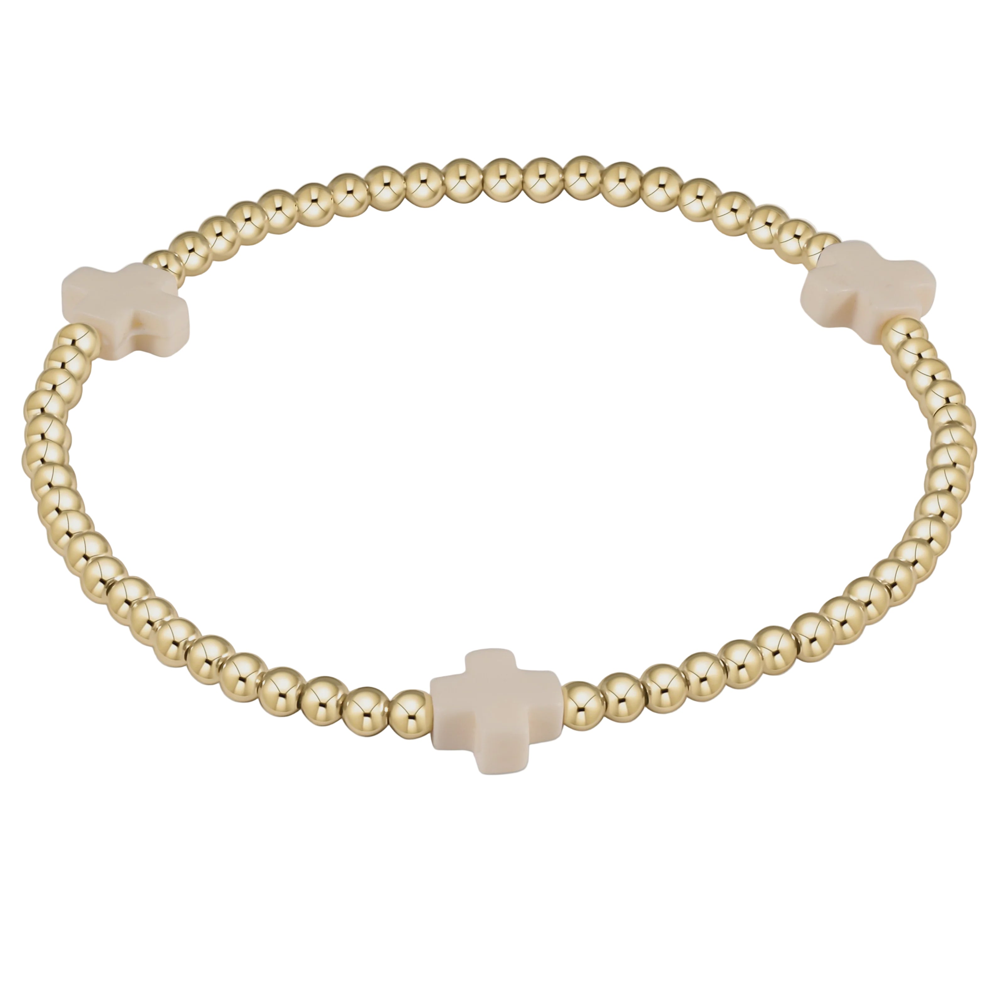 Gold beaded bracelet with beige cross charms on a light gray background