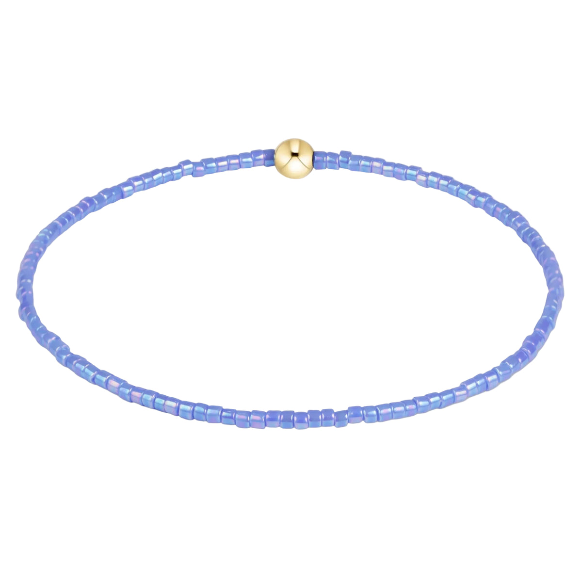 A delicate beaded bracelet made of small iridescent light blue beads with a central gold-toned round charm, displayed on a clean white background.