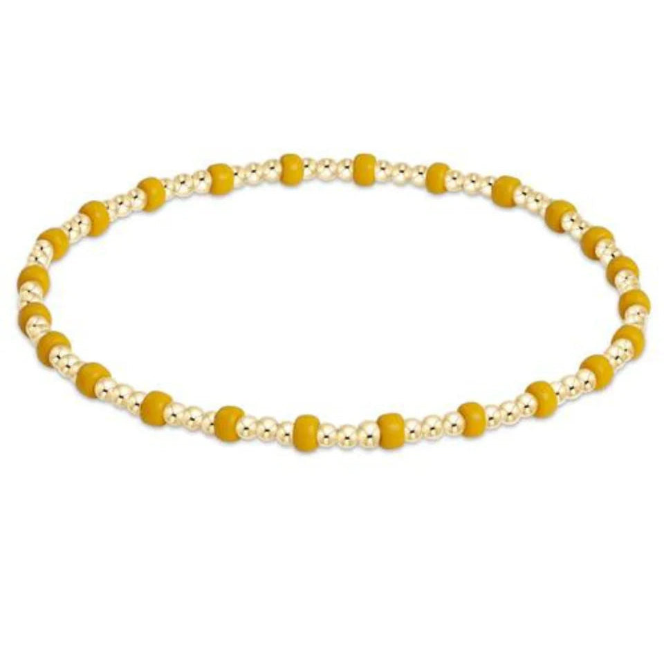 Necklace with yellow and white beads on a white background