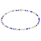 A beaded bracelet with alternating blue and white beads, accented by small gold spacer beads and a polished gold clasp, shown on a plain white background.