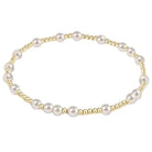 Pearl bracelet with gold accents on a white background