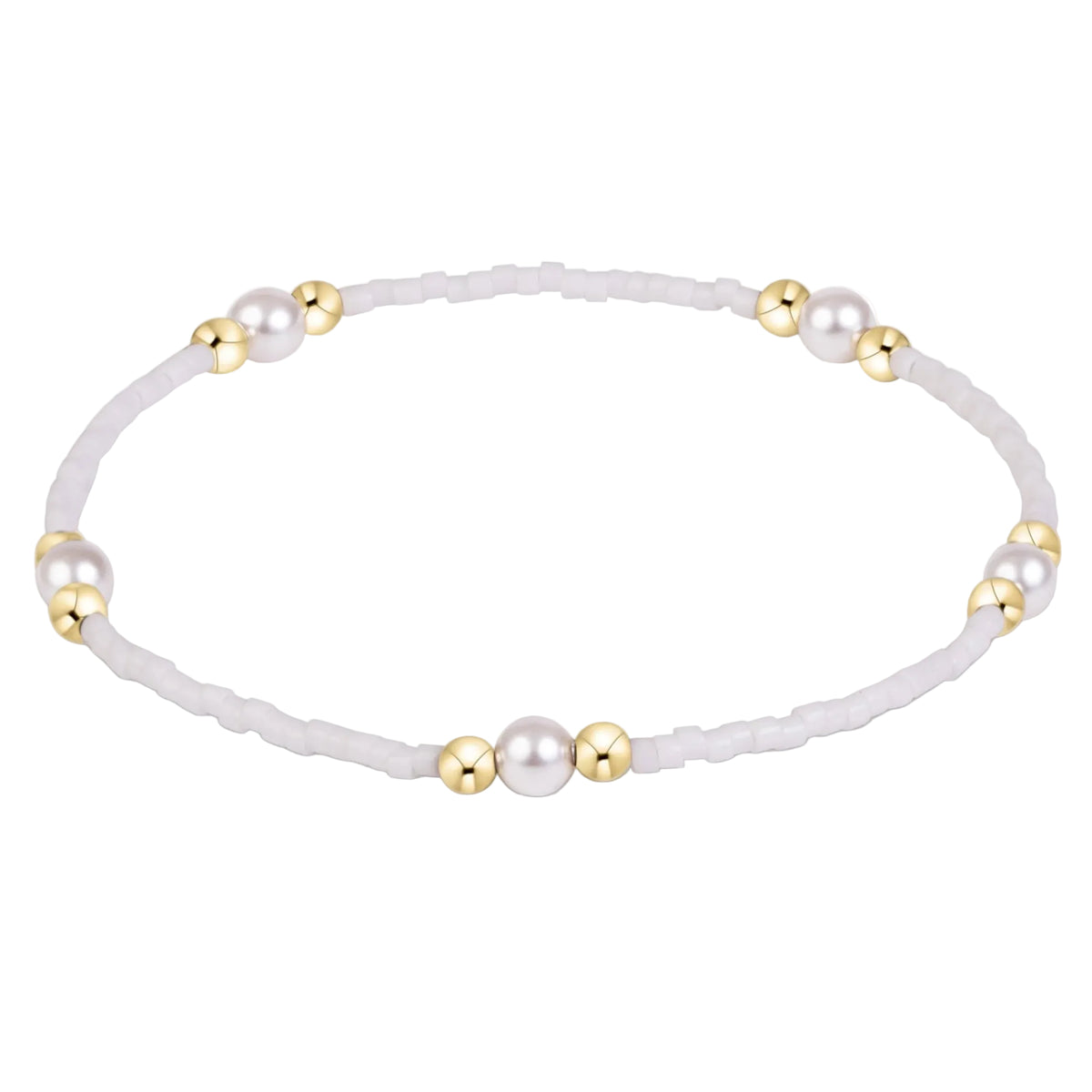 A delicate beaded bracelet with white faux pearls and polished gold spacer beads, arranged in a circle on a clean white background.