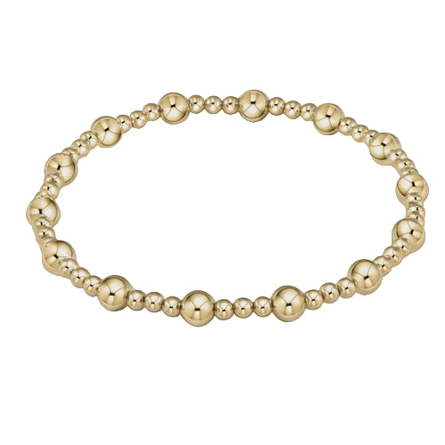 Gold beaded bracelet on a light gray background