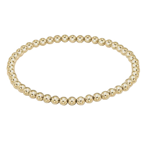 Gold beaded bracelet on a light gray background