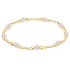 Pearl bracelet with gold accents on a white background