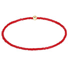 A red beaded bracelet with a small gold-toned bead closure, shown on a plain white background.